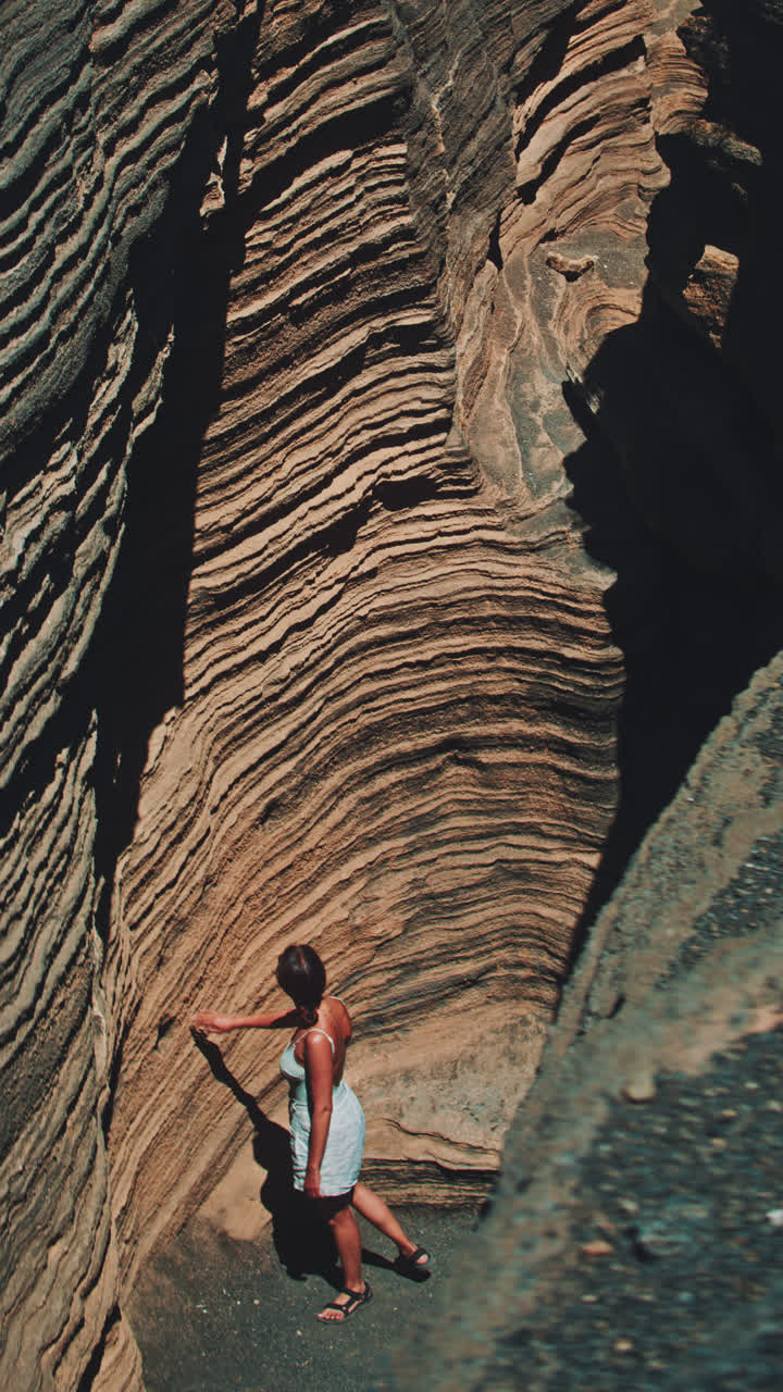 Woman exploring a volcanic canyon