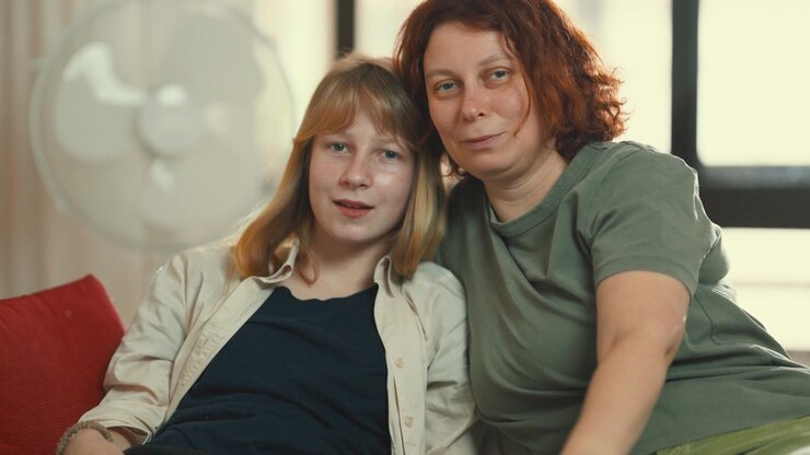 Mother and daughter posing together indoors