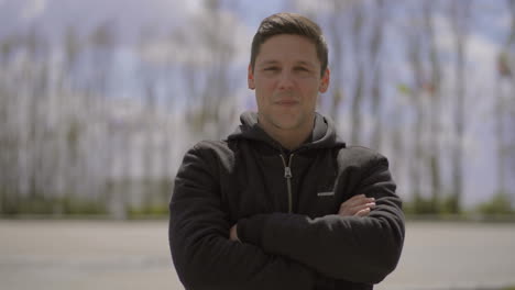 Happy-young-man-looking-at-camera-on-street