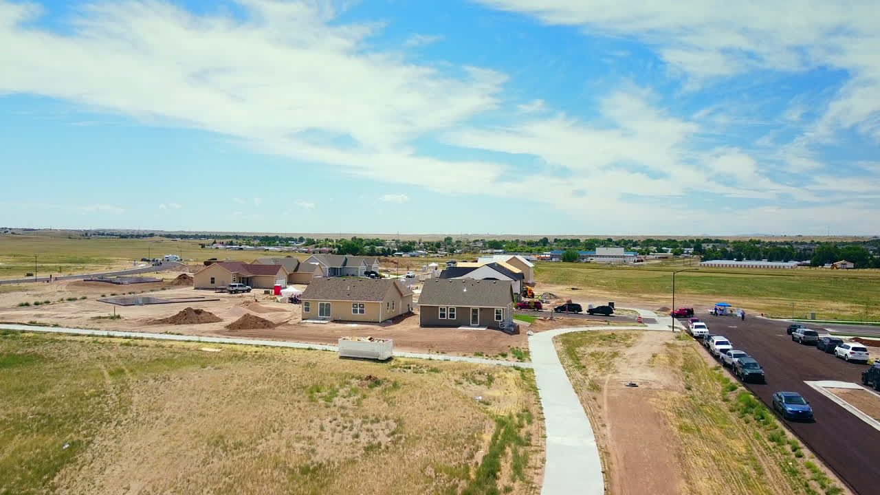Drone up people walking through streets of New Subdivision in rural setting