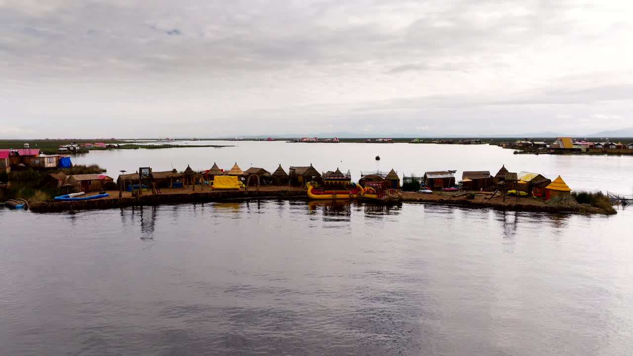 Uros floating islands on Lake Titicaca near Puno in Peru, aerial tracking view