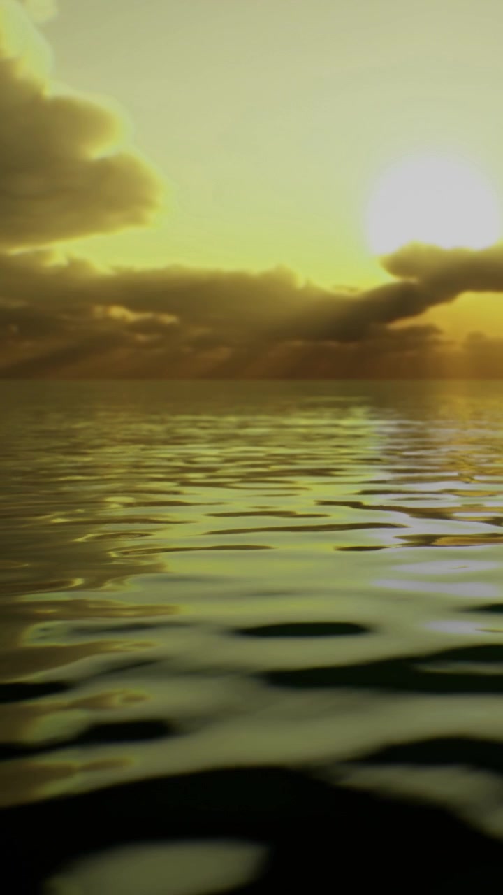 View of the sunset over calm water with light reflections in the sky