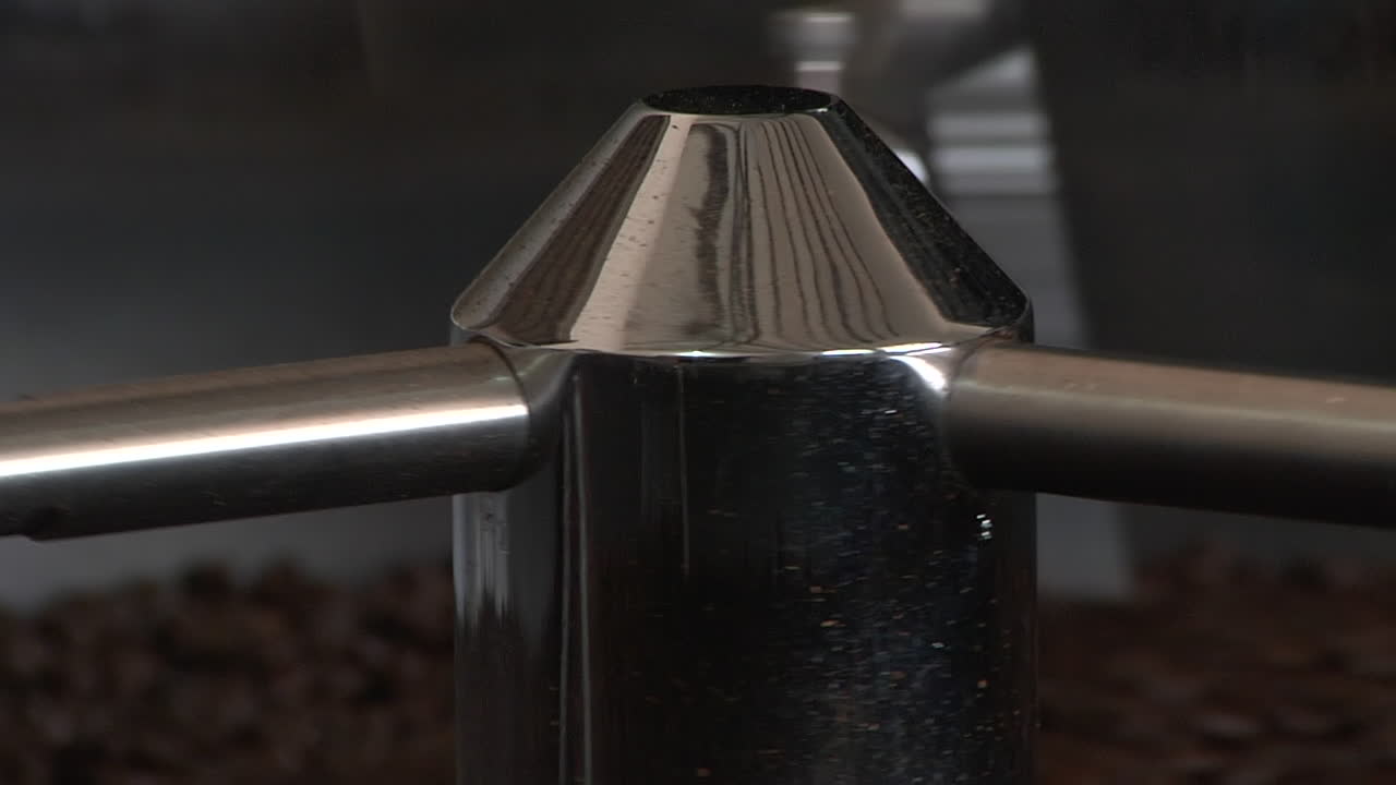 Coffee beans drum roaster mixing closeup