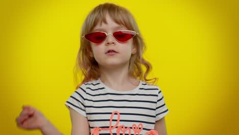 little teen kid child girl in stylish sunglasses listening music, dancing disco, fooling, having fun