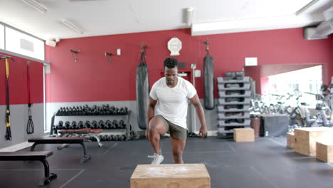 fit african american man performs a step-up exercise at the gym