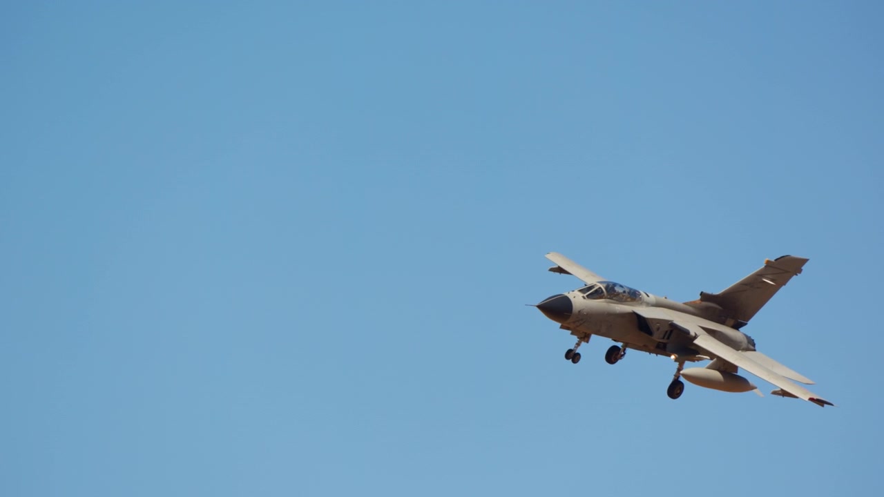 Military jet on landing approach with gear down