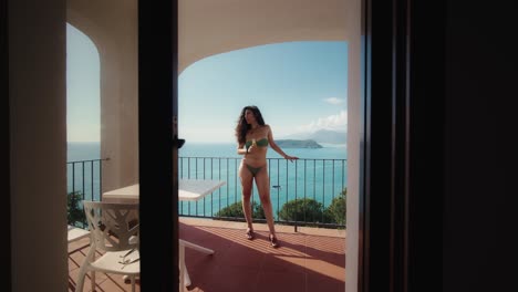 woman at balcony with sea view san nicola arcella italy summer 02