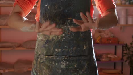 Young-female-potter-working-in-her-studio