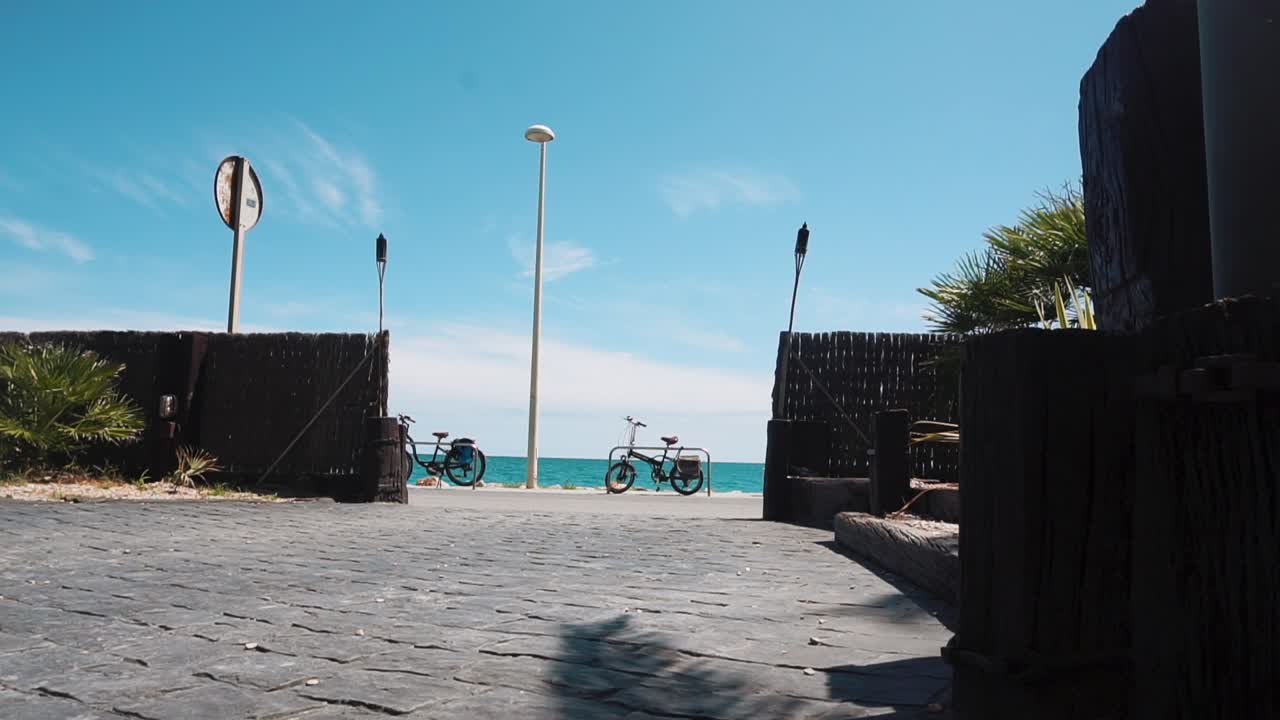 Tourists Walking In Front Of Mar Chica Restaurant With A View Of Seaside Road And Ocean During Summer In Benicarlo, Spain. - timelapse