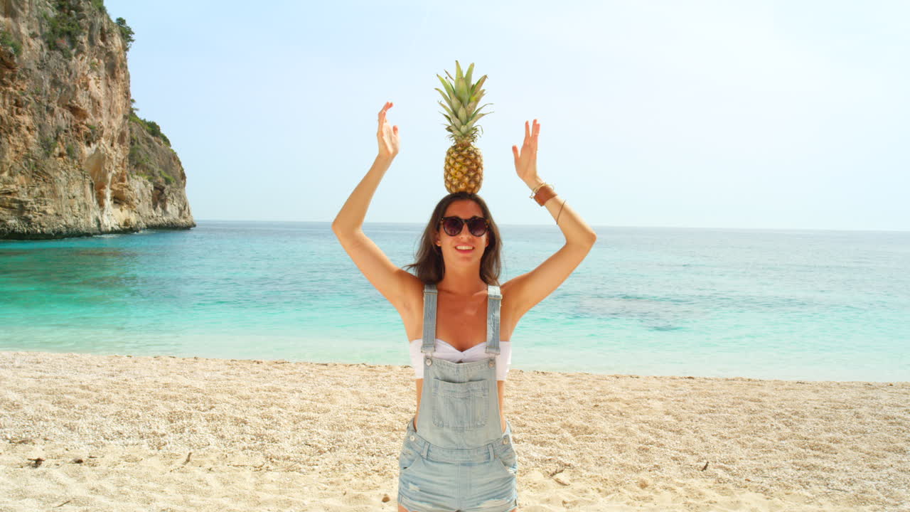 해변에서 파인애플을 가진 여자