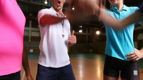 volleyball coach interacting with female players 4k