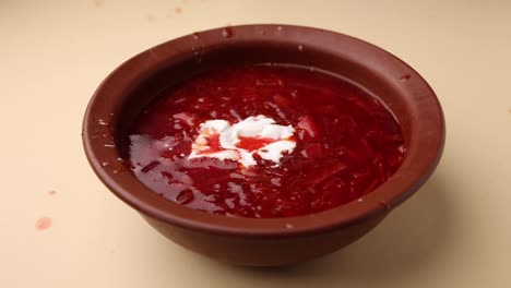 bowl of hot russian borscht soup with cream