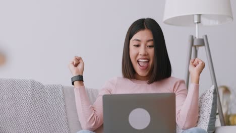 happy woman using a laptop at home