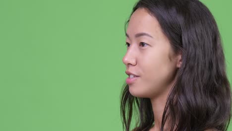 closeup profile view of happy young beautiful multi-ethnic woman being interviewed