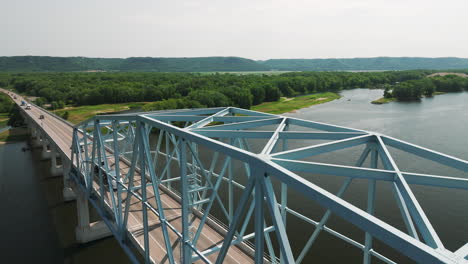 cars driving through the wabasha-nelson truss bridge spanning the mississippi river in minnesota, usa