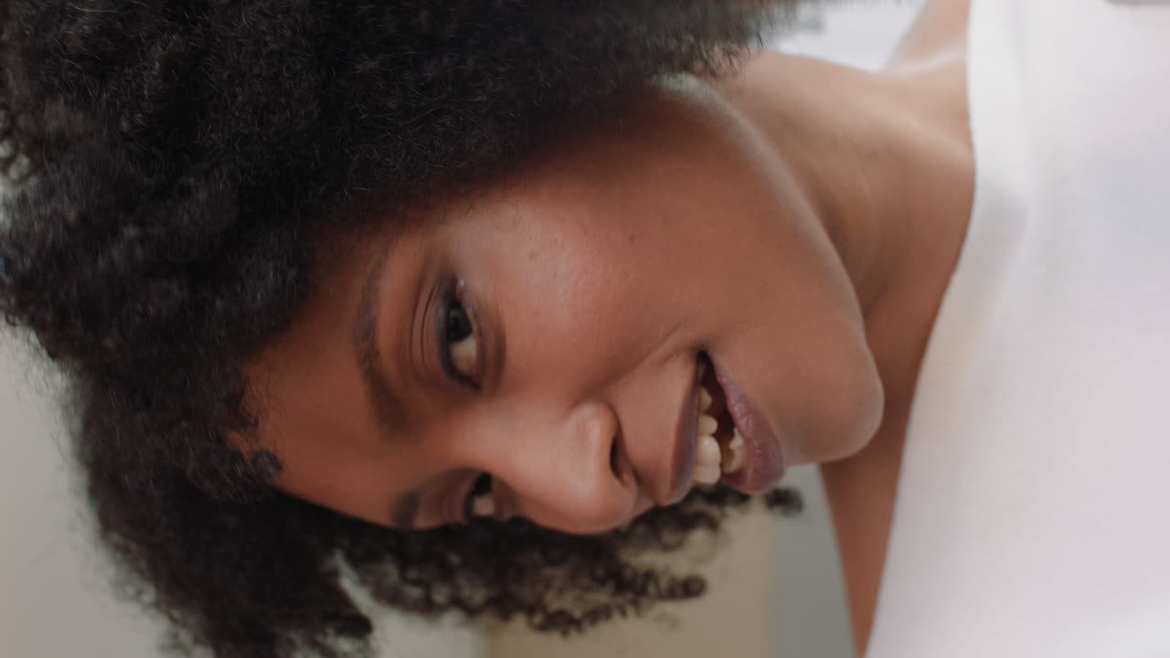 mujer hermosa teniendo video chat usando smartphone en casa mostrando su peinado charlando compartiendo un estilo de vida emocionante disfrutando de la comunicación en línea en pantalla vertical