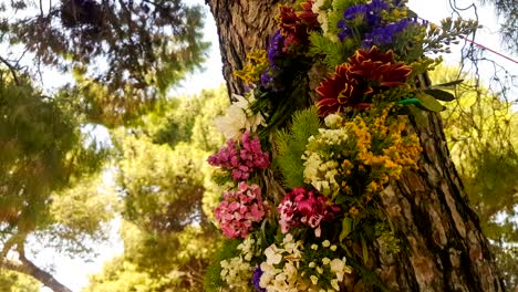 wreath of flowers hanging from a tree on labour day in greece.