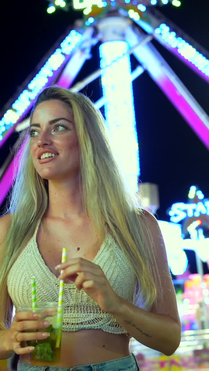 Woman enjoying a cocktail at a carnival