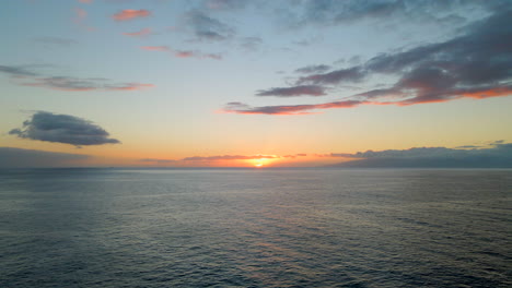 Aerial-view-of-the-sunset-setting-over-the-Atlantic-Ocean-next-to-the-island-of-La-Gomera,-Canary-Islands,-Spain