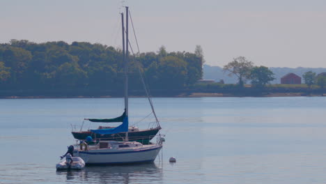 boats on the water at city island in new york, with hart island in the background