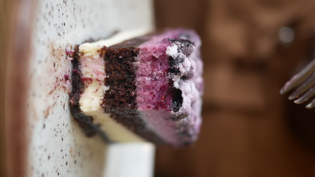 Slice of layered chocolate and berry cheesecake