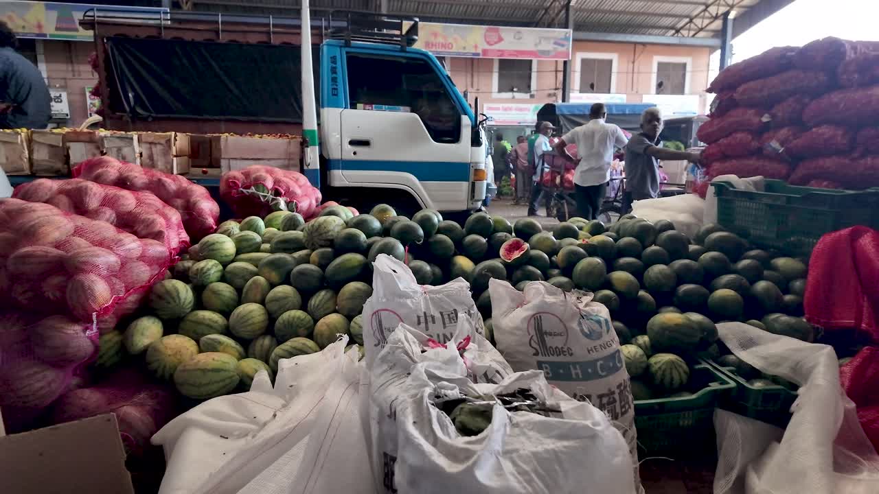 Watermelons and Onions at a Busy Market