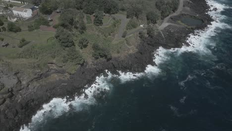 Approaching-Santo-Antonio-black-rocky-coast-from-above,-Sao-Miguel-of-Azores-islands