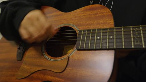 Hand-Strumming-Music-on-a-Guitar