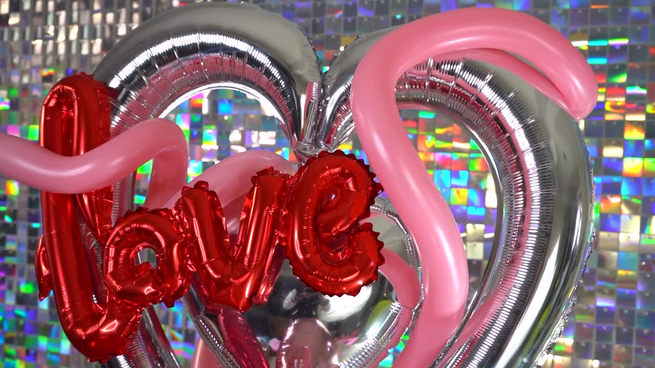 Valentine balloon decoration with glittering wall background for party.