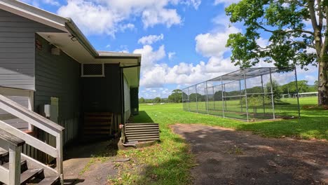 a serene view of a tennis clubhouse and surrounding greenery under bright daylight in mullumbimby, nsw, australia