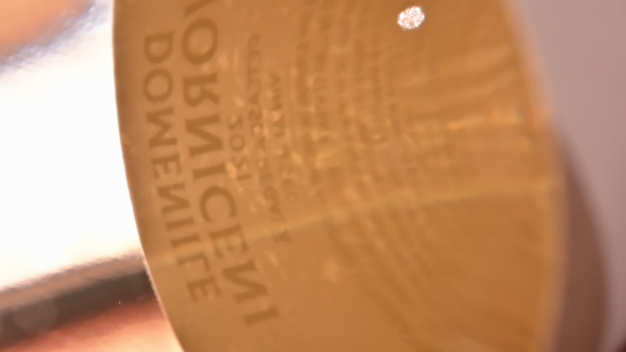 Bottle of white wine on the shelf, macro close up