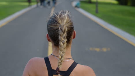 female jogger training on running surface in park. woman exercising outdoors