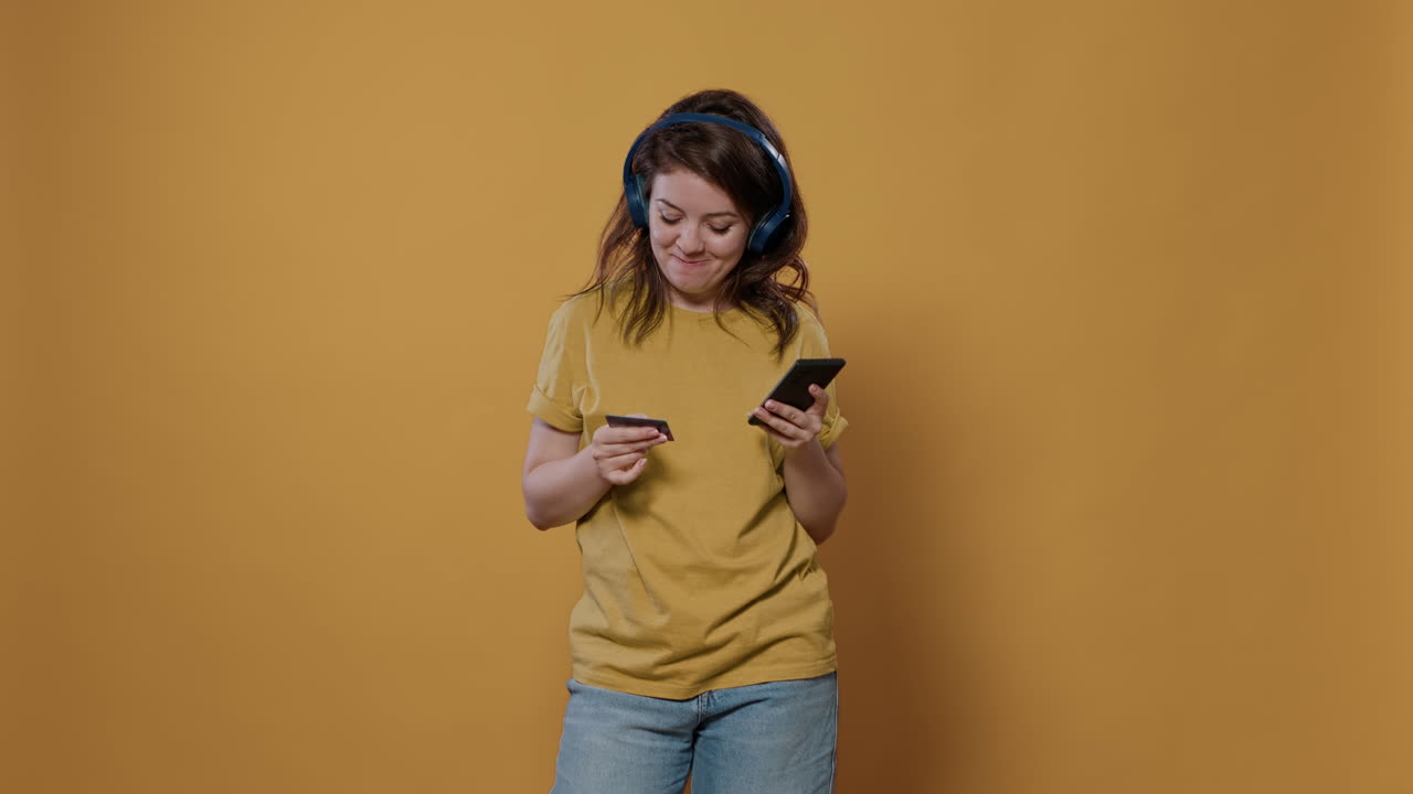 Woman with credit card and phone