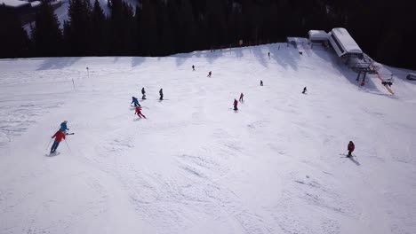 Aerial-view-of-ski-resort-with-people-snowboarding-down-the-hill