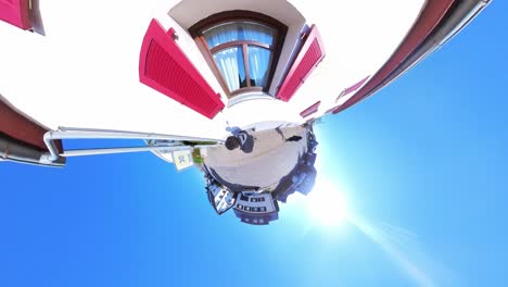 little tiny planet 360 small world view of a man walking through urban area in 4k