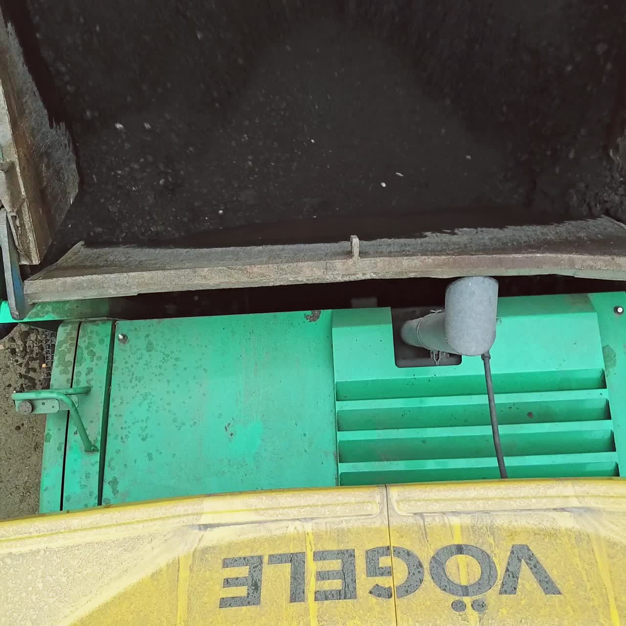 Paving machine working on road construction site