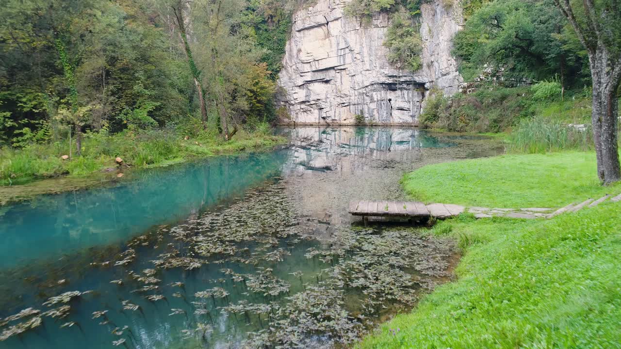 Slowly flying over a stunning little river. White stone reflect in water. Slovenija