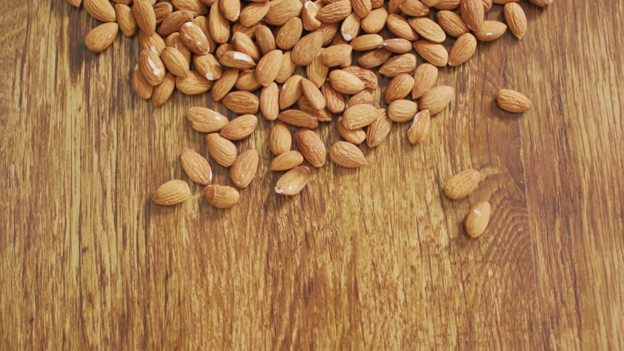 Video of almonds on wooden background