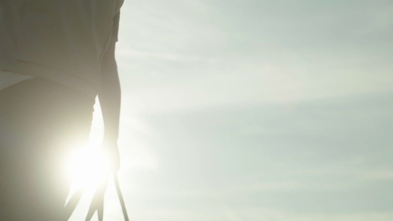 Person walking outdoors in sunlight