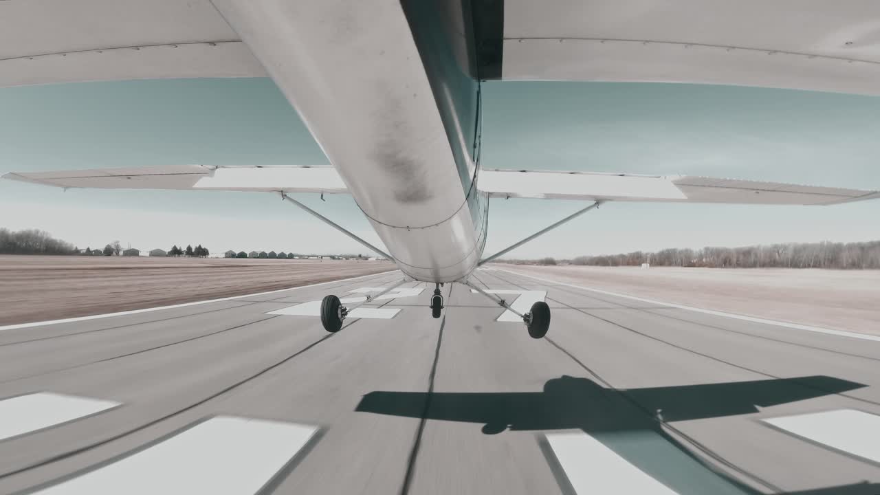 Cessna 150 performs precise centerline landing on a paved runway at a towered airport.