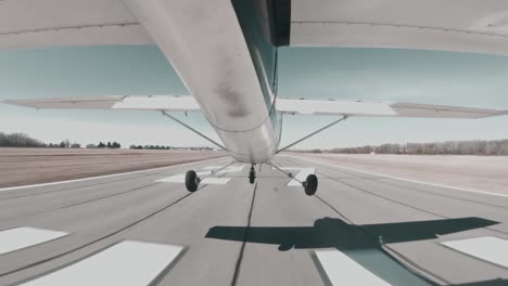 cessna 150 performs precise centerline landing on a paved runway at a towered airport.