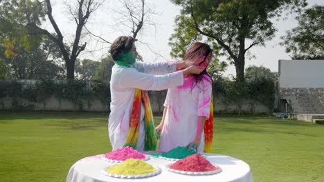 indian girl putting colors on her husband kurta