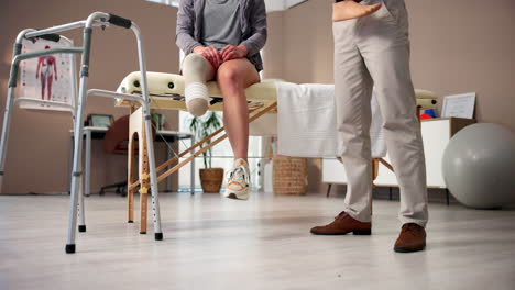 physical therapist examining a patient with a prosthetic leg