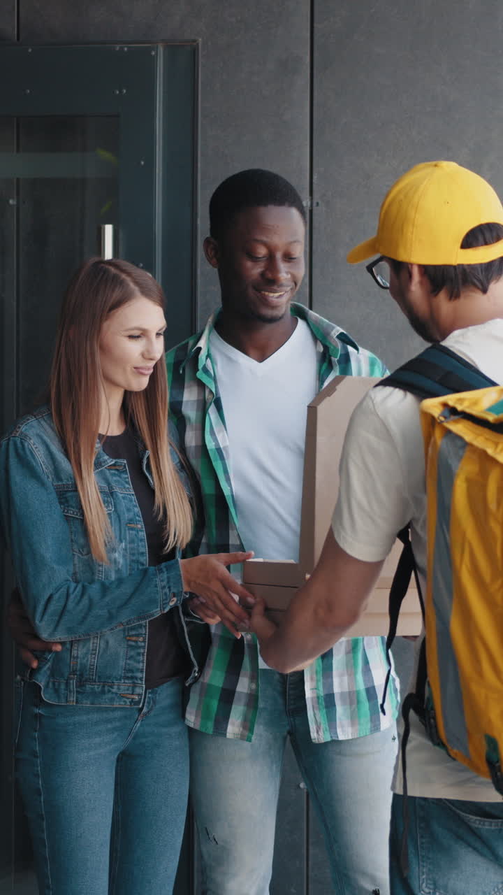 Couple receiving pizza delivery at their doorstep