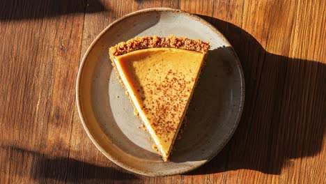 delicious slice of creamy pumpkin pie on rustic plate