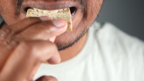 man eating a cracker