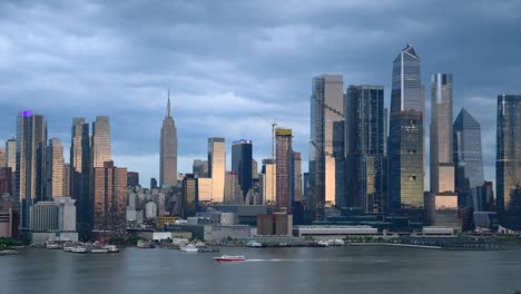 manhattan skyline with empire state building reflecting setting sunlight, dusk travel destination, 4k video