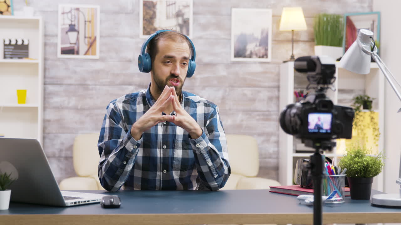 A man vlogging with headphones