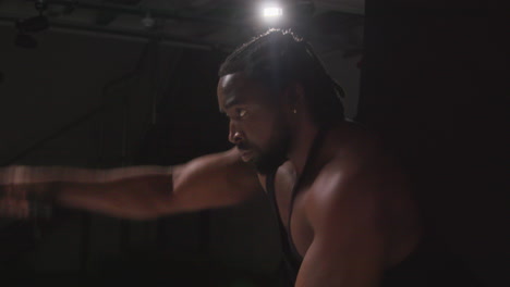 Close-Up-Studio-Shot-Of-Male-Athlete-Training-In-Fitness-Vest-Using-Battle-Ropes-Shot-Against-Black-Background-4