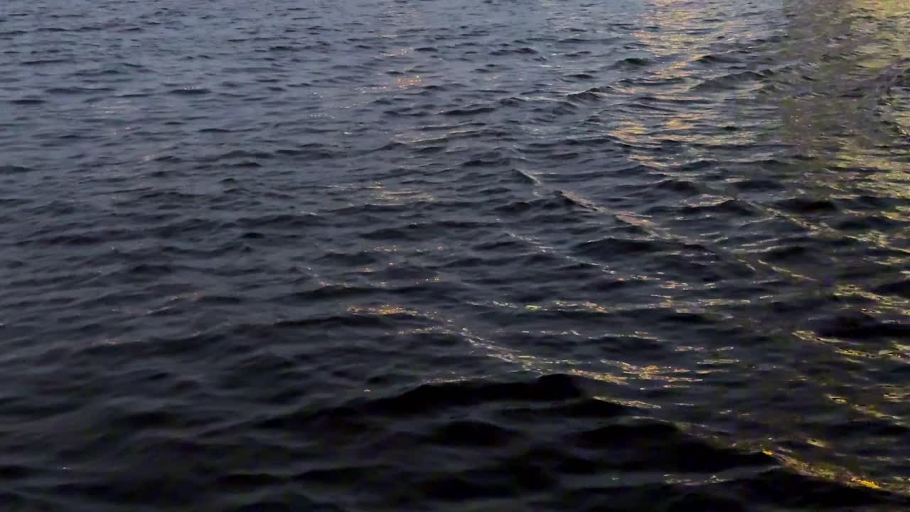 Calm sea waters reflecting the sunset sky
